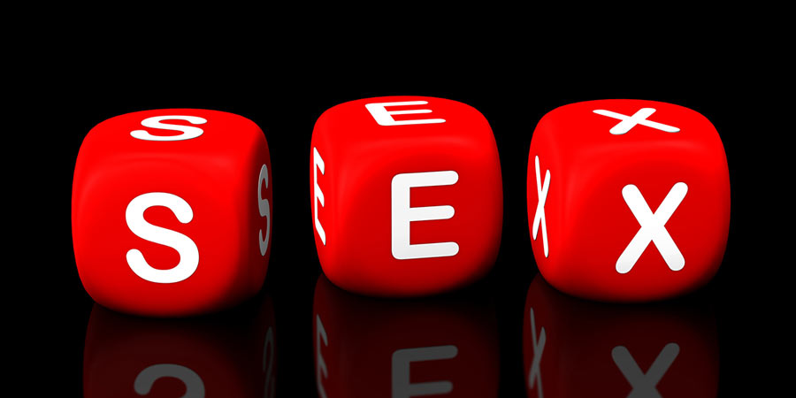 Three red dice spelling the word SEX
