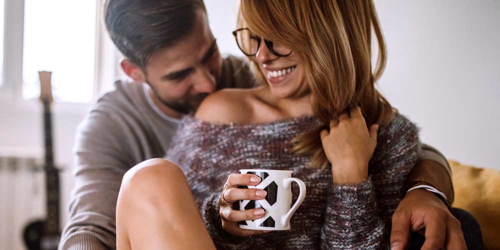 Young couple cuddling and laughing