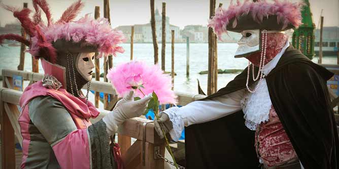 Couple in Venice wearing carnival masks to mimic Casanova and his lover