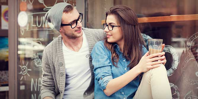 Young couple dating and sharing a coffee