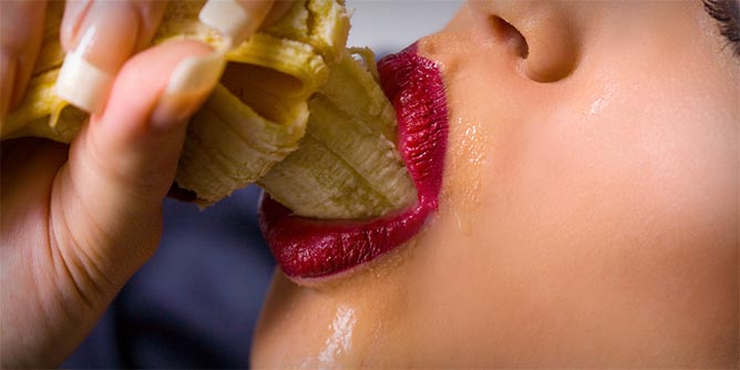 Woman deep throating a banana to simulate oral sex