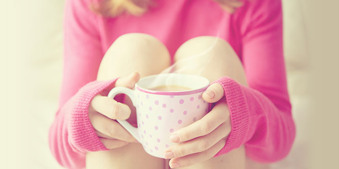 Young woman holding a cup of tea to mimic the analogy in the consent youtube video