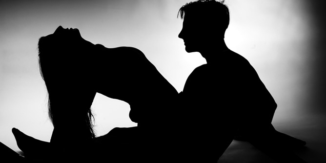 Silhouette of a man and woman making love 