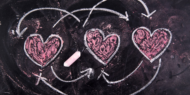 Drawing of three pink love hearts with arrows to indicate bisexuality