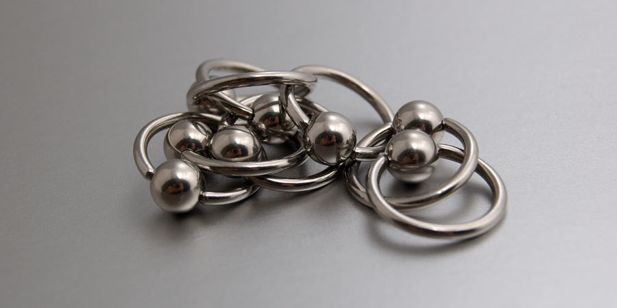 A handful of stainless steel piercing rings linked together