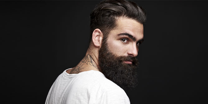 Sexy man with a full beard and tattoos