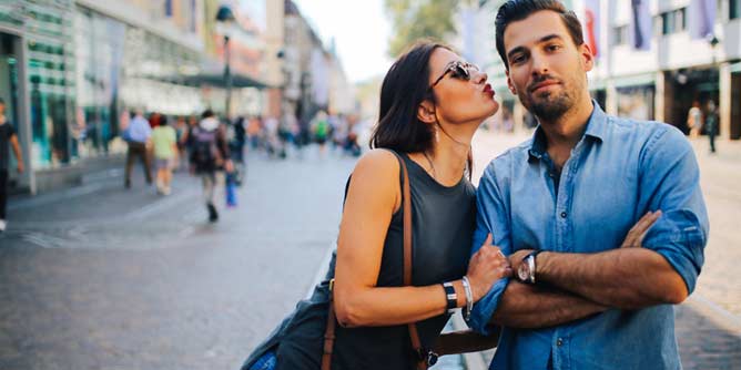 Woman giving her boyfriend a kiss on Valentine's Day