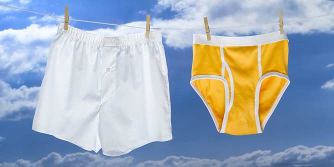 Men's boxer shorts and men's briefs hanging on a clothes line