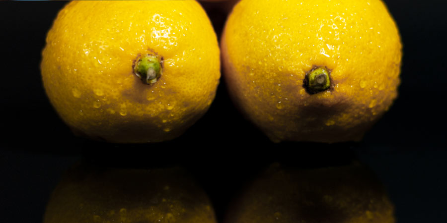 Close up of two lemons pointing to the camera to mimic nipples on breasts