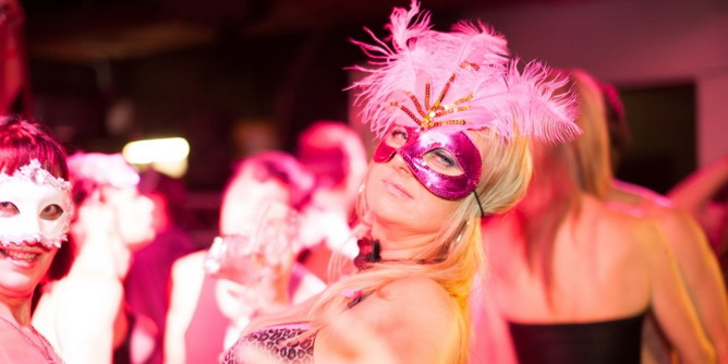 Two women wearing masks attending Saints & Sinners Ball, a swingers party in Australia