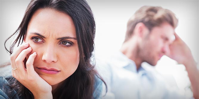 Woman and man turned away from each other and both looking emotional