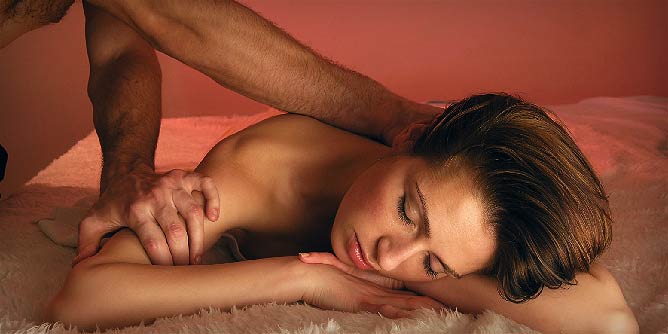 Man giving a woman an erotic massage 