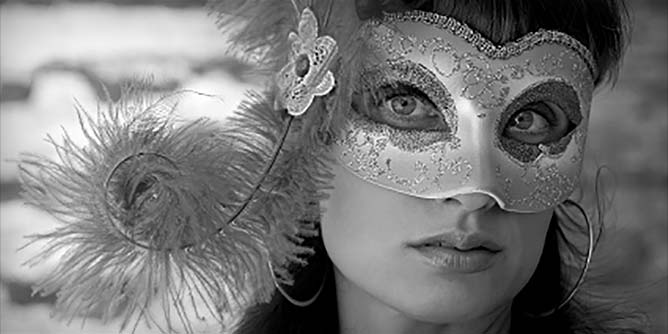 Beautiful woman wearing an elaborate carnivale mask 